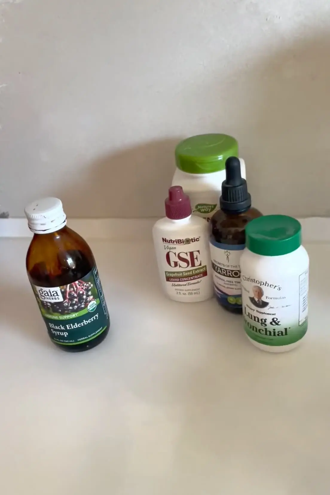 A lineup of immune-boosting supplements including elderberry syrup, grapefruit seed extract, and herbal tinctures for natural cold and flu relief.